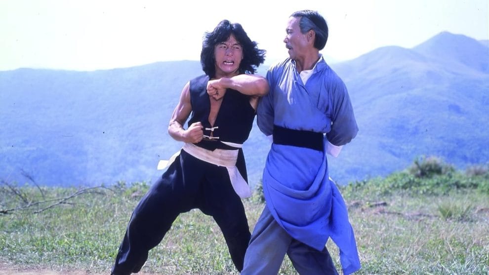 Jackie Chan in The Young Master throwing an elbow at an opponent.