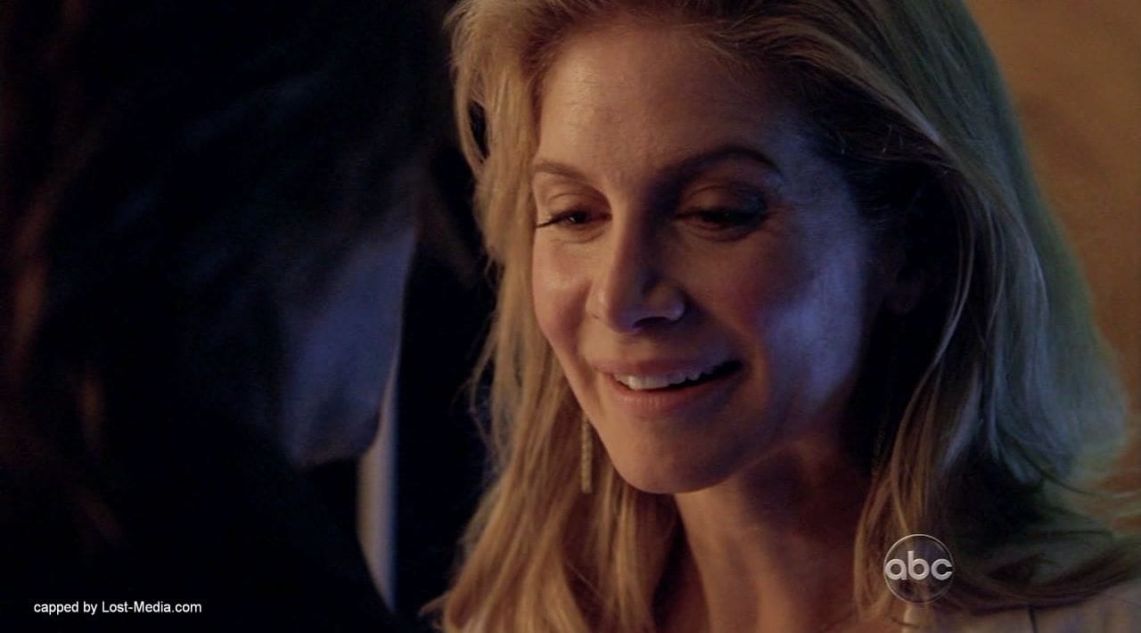 Juliet in Lost, looking at Sawyer, smiling.