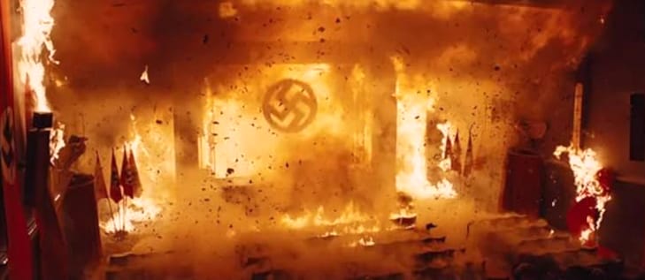 A burning theater, and on the flame-engulfed screen is a swastika.