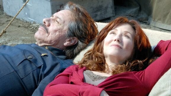 A shot of Laura Roslin and Bill Adama lying on a pillow outside, looking up at the sky.